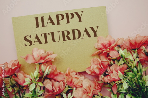 Happy Saturday typography text with flowers on pink background