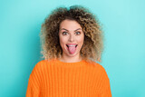 Photo of funny positive lady stick out tongue have fun wear orange knitted sweater isolated teal color background