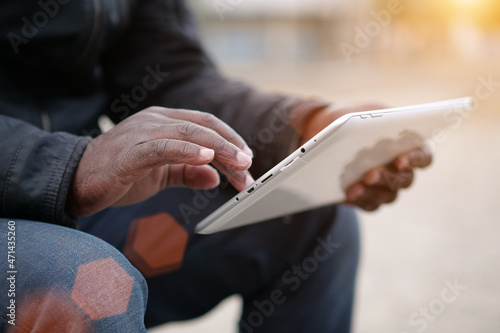 African american man uses tablet computer. Black mans hands holds a tablet pc
