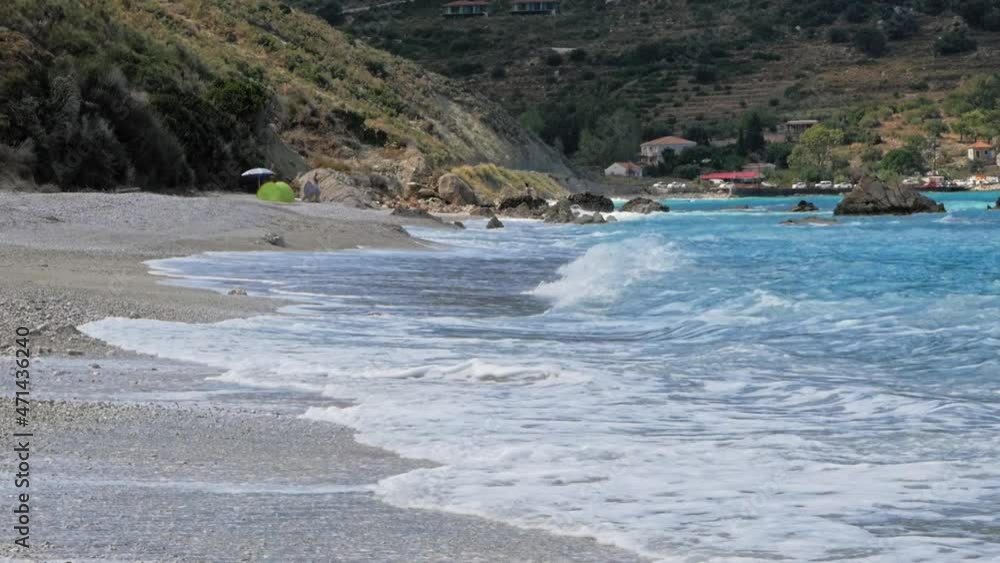 Foamy Ocean Waves Rolling On The Shore At Agia Kiriaki Beach In Greece During Summer - wide shot Foamy Ocean Waves Rolling On The Shore At Agia Kiriaki Beach In Greece During Summer - wide shot