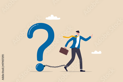 Struggle with unanswered question, problem or difficulty, hard questions or unsolvable quest concept, frustrated businessman chained with huge large question mark burden.