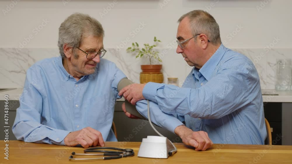 Two elderly men choose pills for treatment Two elderly men choose pills for treatment