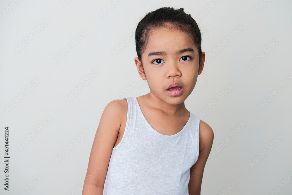 Asian little girl looking forward with confused expression Asian little girl looking forward with confused expression