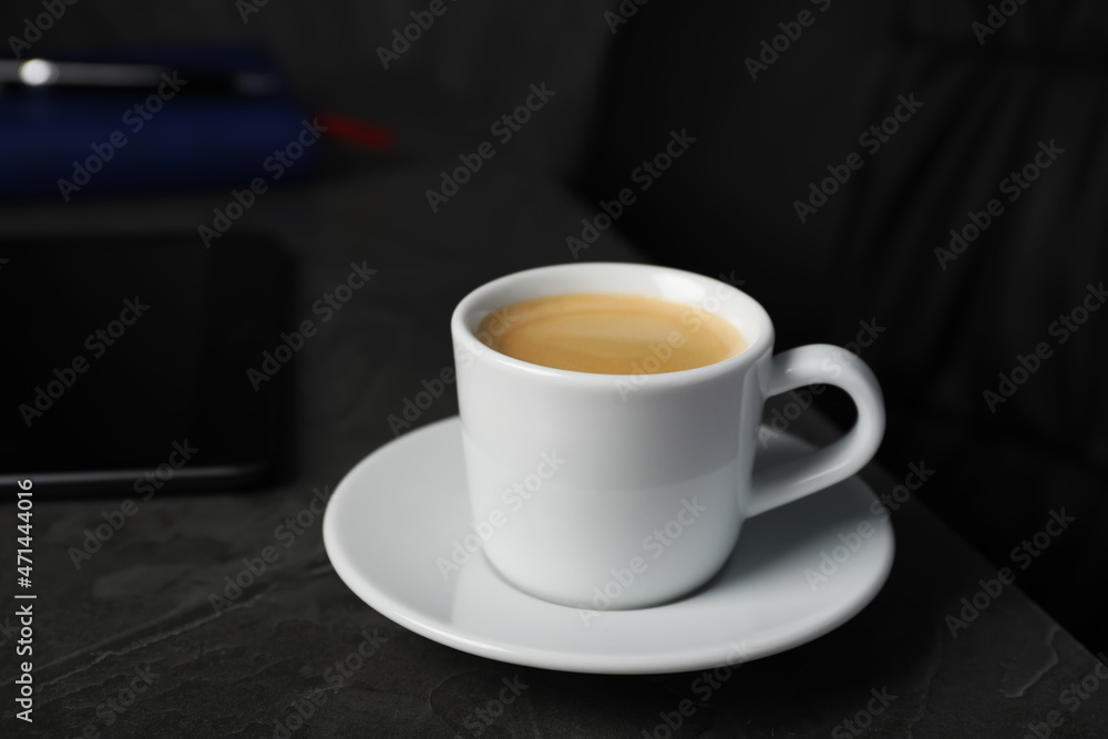 Coffee Break at workplace. Cup of hot espresso on grey table Coffee Break at workplace. Cup of hot espresso on grey table