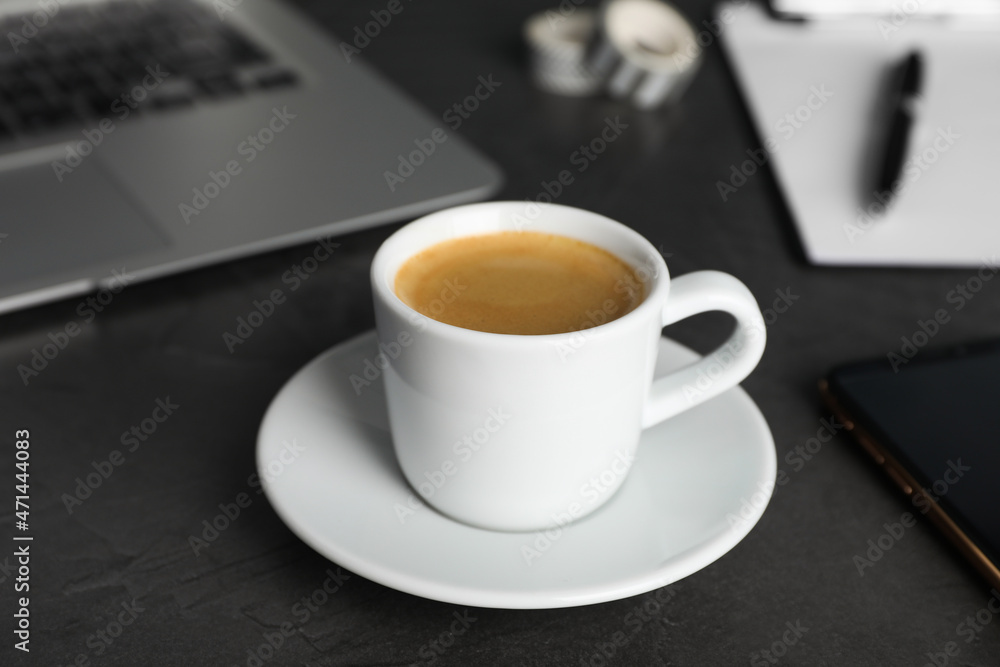 Coffee Break at workplace. Cup of hot espresso on grey table Coffee Break at workplace. Cup of hot espresso on grey table