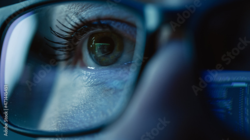 Super Close-up on Female Eye, Software Engineer Working on Computer, Programming Reflecting in Glasses. Developer Working on Innovative e-Commerce Application using Machine Learning, AI, Big Data