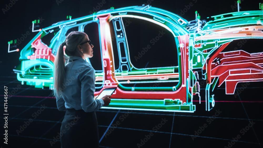 Naklejka premium Innovative Green Energy Startup: Female Engineer Designing Electric Car Using Tablet Computer and Big Wall Screen to Analyse Prototype. Concept for Sustainable Zero Emissions Carbon Neutral Vehicle