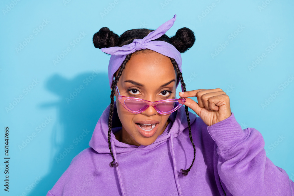 Photo of young cool funky black girl hand touch glasses hipster pin up hairband isolated over blue color background Stock Photo Adobe Stock