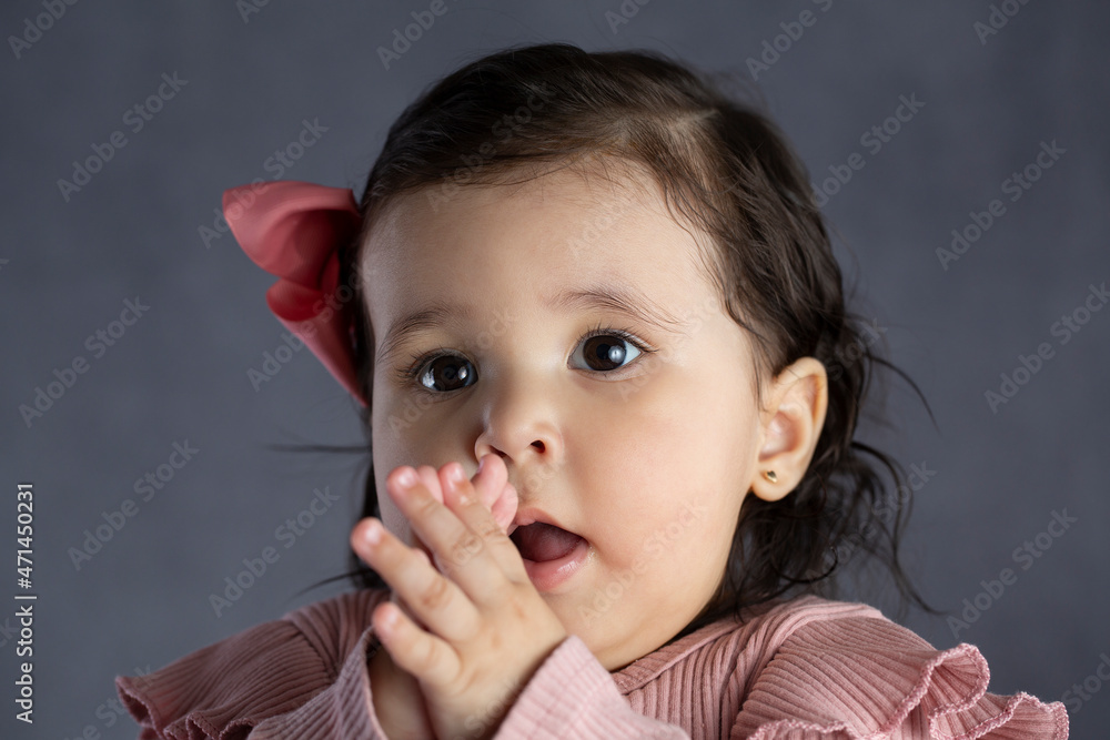 Cute One Year Old Baby Girl Learning How To Clap During A Studio Shoot