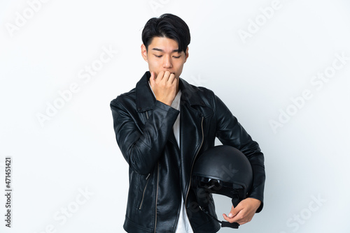 Chinese man with a motorcycle helmet isolated on white background having doubts
