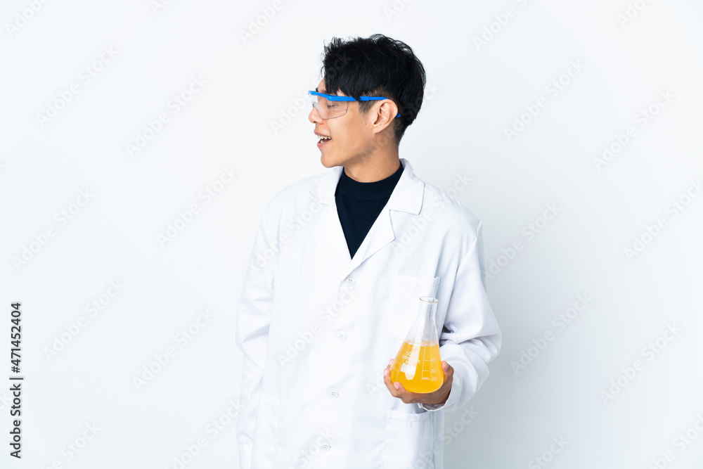 Young Chinese scientific man isolated on white background laughing in lateral position Young Chinese scientific man isolated on white background laughing in lateral position