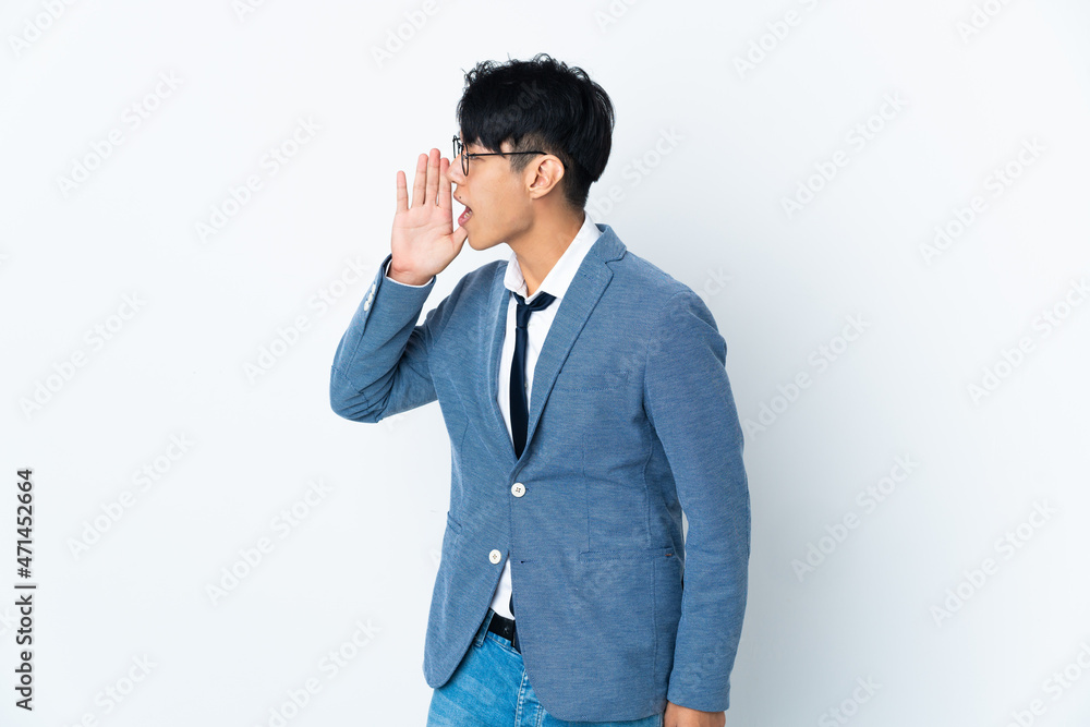 Young Chinese business man isolated on white background shouting with mouth wide open to the side Young Chinese business man isolated on white background shouting with mouth wide open to the side