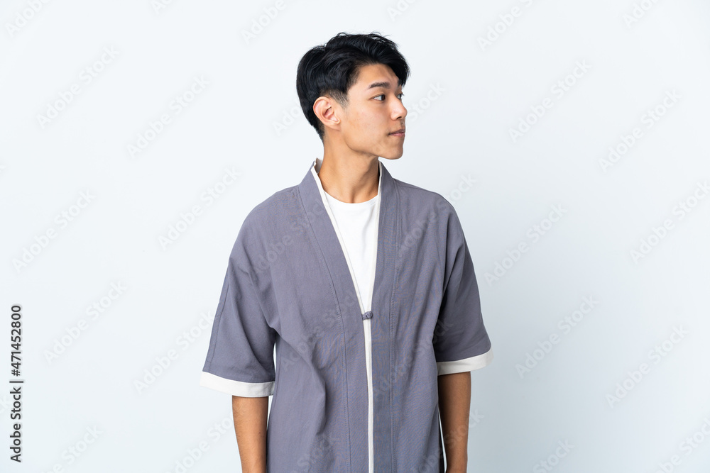 Young Chinese man isolated on white background looking to the side Young Chinese man isolated on white background looking to the side