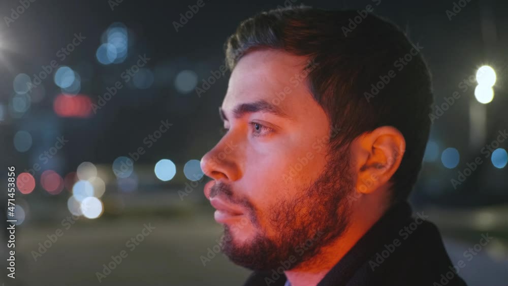 Portrait of young business man walking on the night city Portrait of young business man walking on the night city