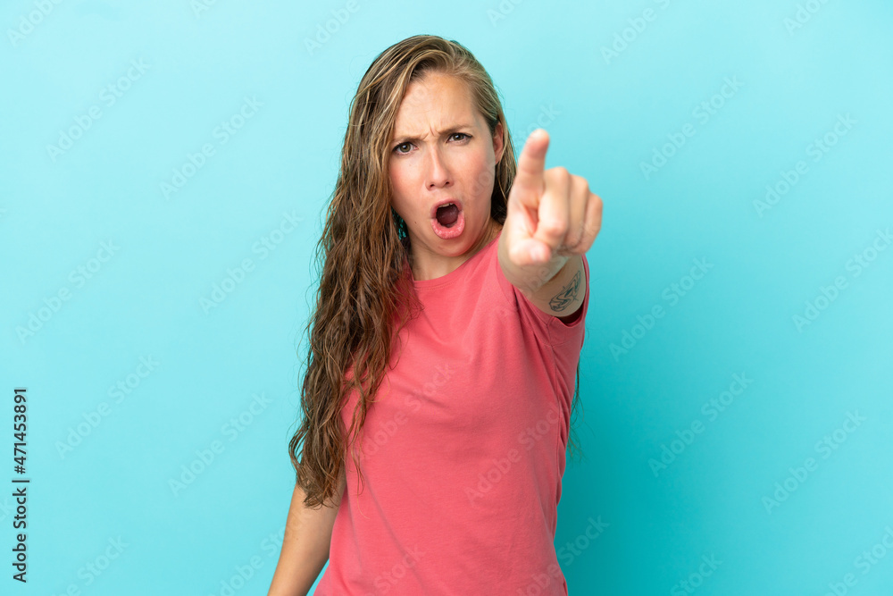 Fototapeta premium Young caucasian woman isolated on blue background frustrated and pointing to the front