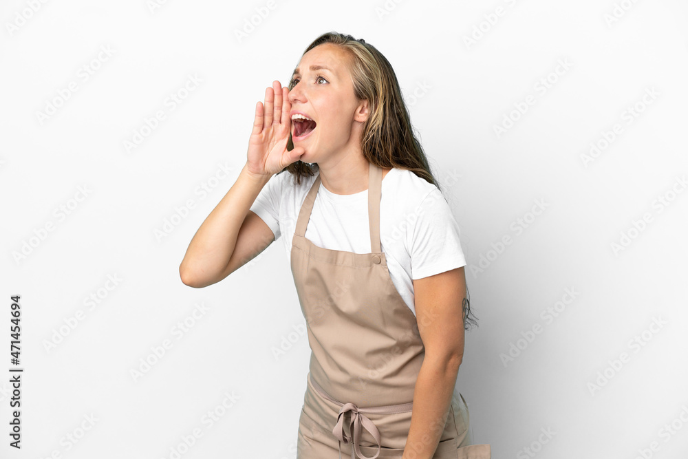 Restaurant waiter caucasian woman isolated on white background shouting with mouth wide open to the lateral Restaurant waiter caucasian woman isolated on white background shouting with mouth wide open to the lateral