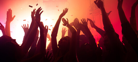 Photo of bachelors clubbers guys ladies silhouettes enjoy electro star private occasion raise hands up on red bright disco