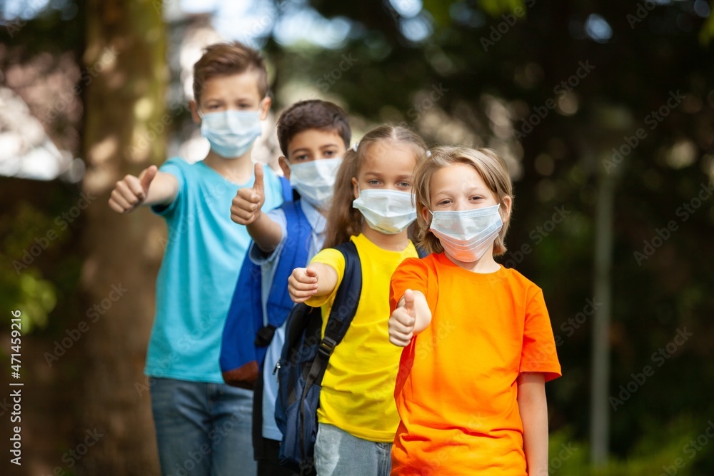 children wearing face medical mask back to school after covid-19 quarantine concept children wearing face medical mask back to school after covid-19 quarantine concept