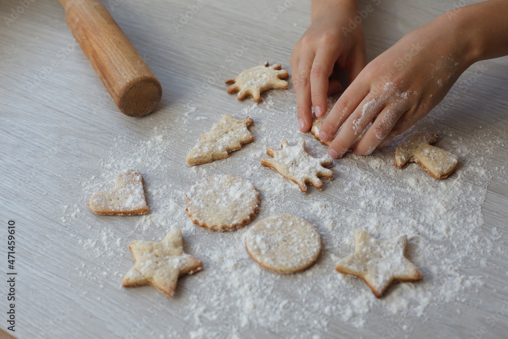 kids Little hands with handmade cookie on wooden table. Christmas gingerbreads, different shapes. kids Little hands with handmade cookie on wooden table. Christmas gingerbreads, different shapes.