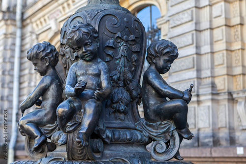 Bronze floor lamps are decorated with putti figures that represent various crafts in front of the A. L. Stieglitz Academy in St. Petersburg, Russia