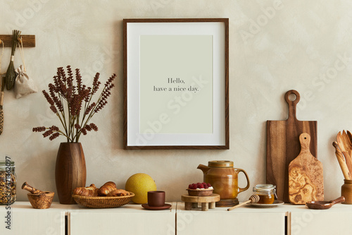 Photography Stylish and modern kitchen interior composition with mock up poster frame, beige wooden sideboard, plants and retro inspired accessories