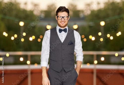 Fototapeta fashion, style and vintage concept - happy man in festive suit and eyeglasses at