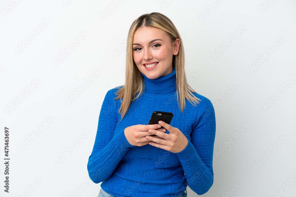 Young caucasian woman isolated on white background sending a message with the mobile Young caucasian woman isolated on white background sending a message with the mobile