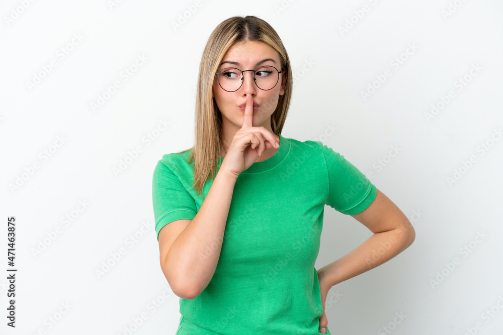 Young caucasian woman isolated on white background showing a sign of silence gesture putting finger in mouth Young caucasian woman isolated on white background showing a sign of silence gesture putting finger in mouth