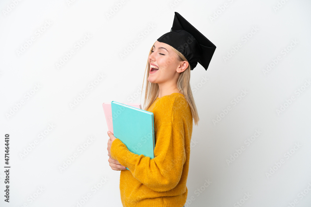 Young student caucasian woman isolated on white background laughing in lateral position Young student caucasian woman isolated on white background laughing in lateral position