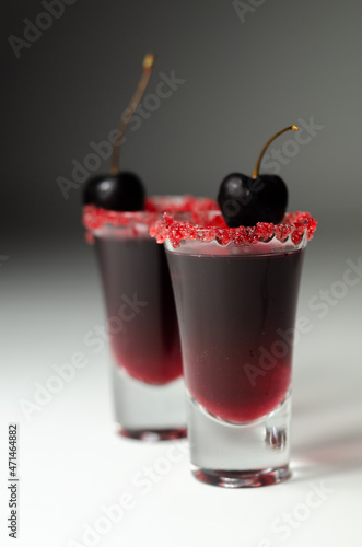 Wallpaper Mural Ruby red cocktail based on vodka, cherry liqueur and syrup in drink shot glass, decorated with fresh cherry and red sugar Torontodigital.ca