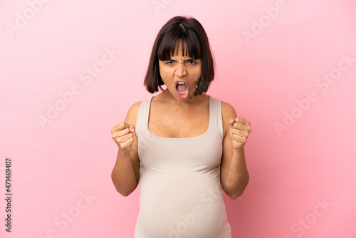 Young pregnant woman over isolated pink background frustrated by a bad situation