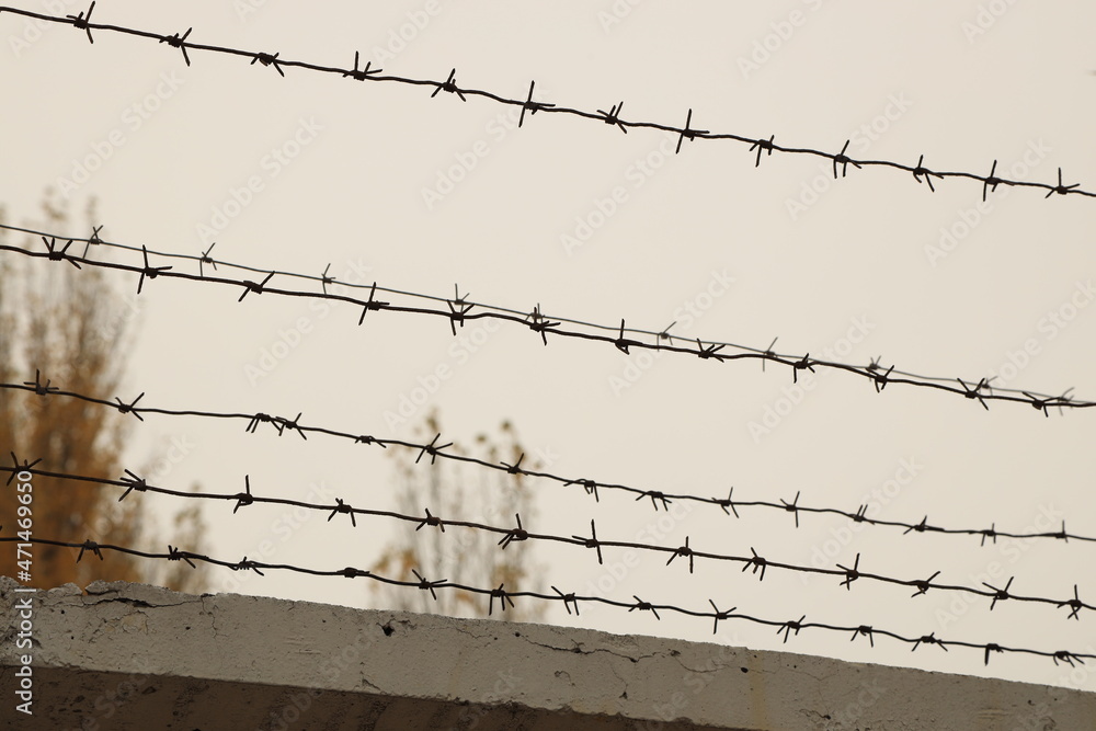 barbed wire on cloudy sky background barbed wire on cloudy sky background