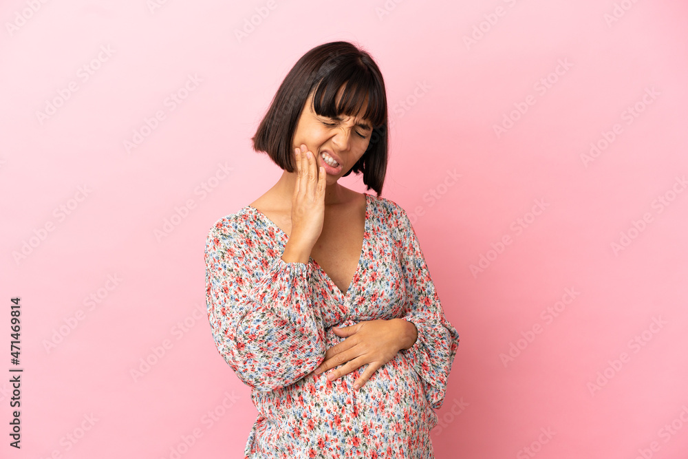 Young pregnant woman over isolated pink background with toothache Young pregnant woman over isolated pink background with toothache
