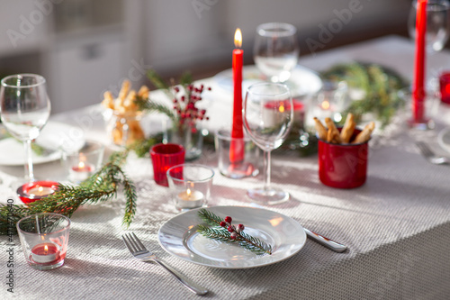 winter holidays  dinner party and celebration concept - close up of christmas table serving at home