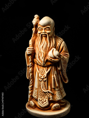 Macro of a small figure of the god Shu (one of the Three Star Elders). Shu is the god of longevity, health and immortality - with a peach in his hand