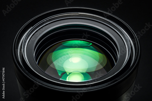 Camera lens with beautiful green optical highlights. Macro photography, full frame. Beautiful Camera Lens background