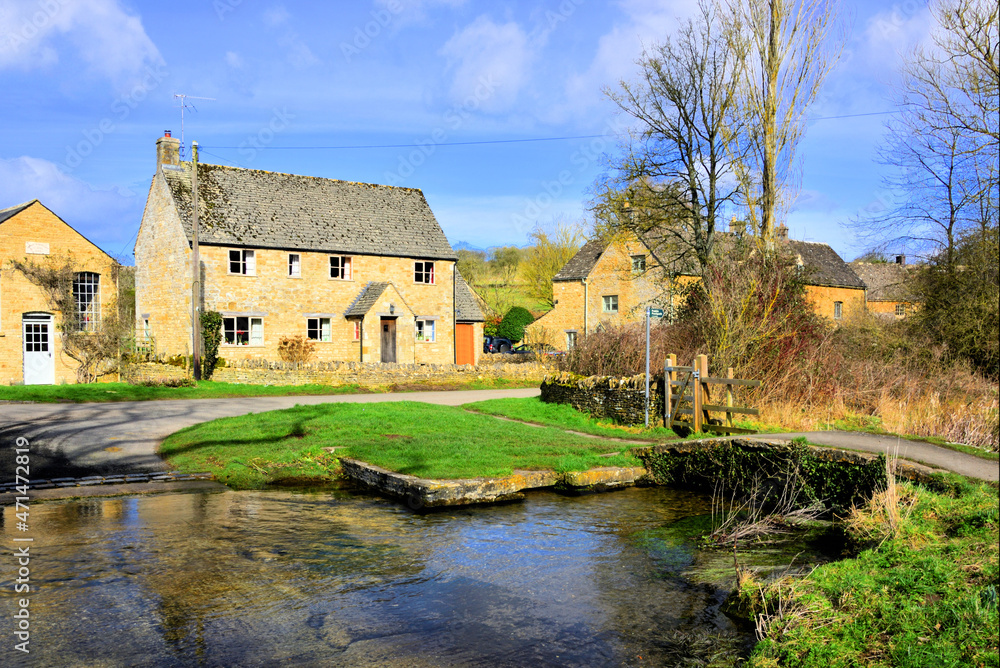 The River Eye Ford and Small Footbridge at Upper Slaughter in the Cotswolds The River Eye Ford and Small Footbridge at Upper Slaughter in the Cotswolds