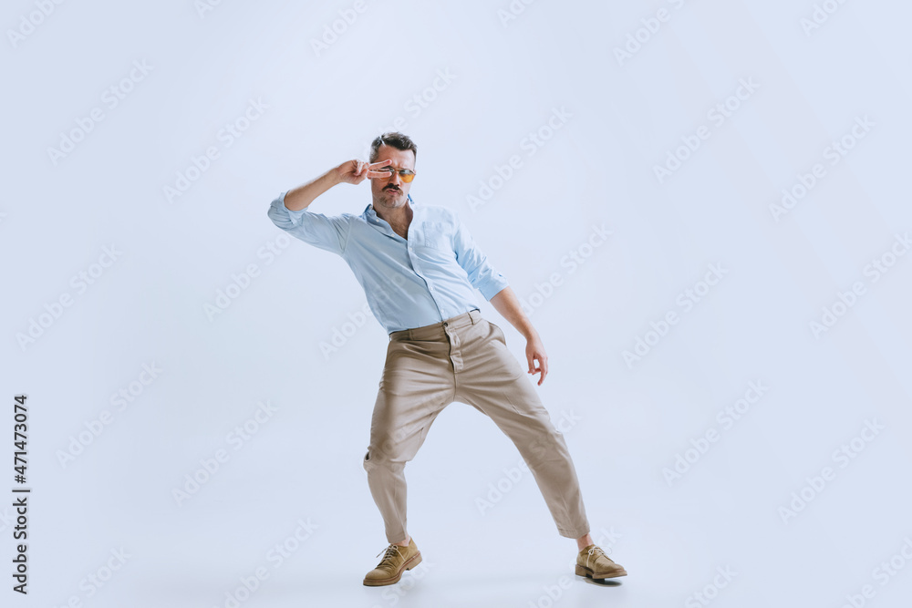 Portrai of young man, hipster or dandy dancing rock-and-roll or swing isolated on white background. retro vintage style Portrai of young man, hipster or dandy dancing rock-and-roll or swing isolated on white background. retro vintage style