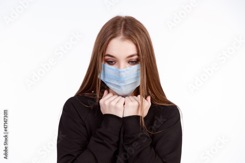 Young girl in a protective mask from the virus on a white background