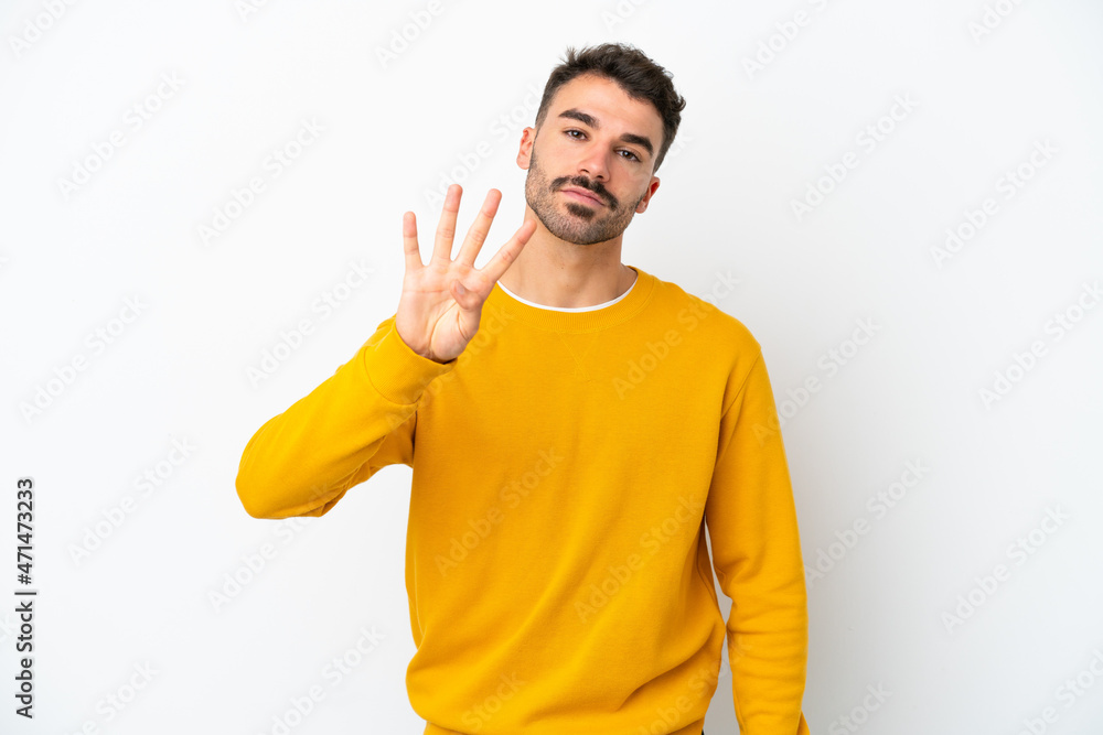 Fototapeta premium Young caucasian man isolated on white background happy and counting four with fingers