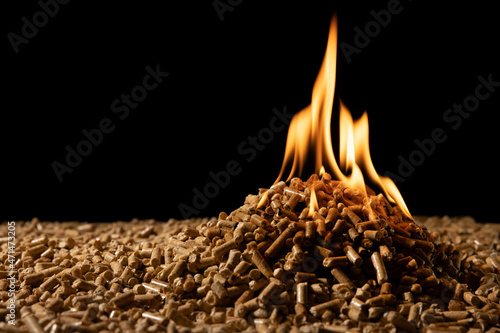 biomass - wood pellets burning. biofuel and renewable energy. copy space photo