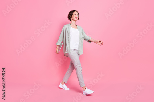 Full length photo of cool bob hairdo lady hold laptop go wear grey green suit isolated on pink background