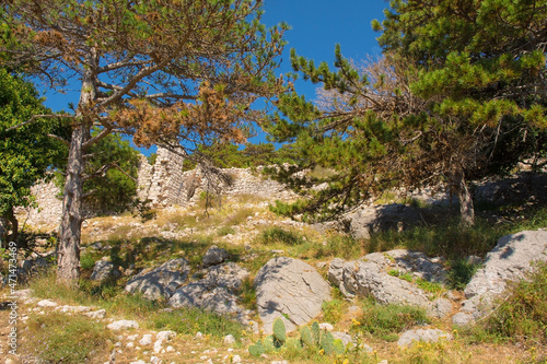 The ruins of the medieval Baska Citadel, Kastel Baska, overlooking the south Krk island town of Baska in the Primorje-Gorski Kotar County of western Croatia
