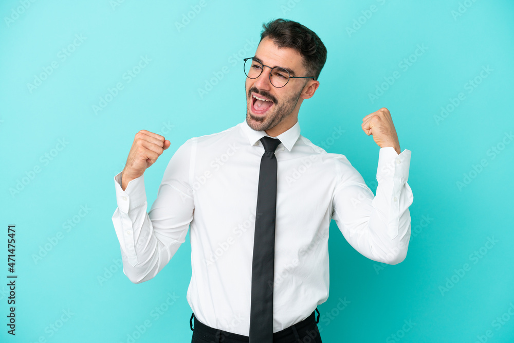 Business caucasian man isolated on blue background celebrating a victory Business caucasian man isolated on blue background celebrating a victory