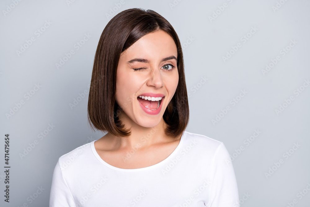 Photo of coquette bob hairdo millennial lady blink wear white shirt isolated on grey color background Photo of coquette bob hairdo millennial lady blink wear white shirt isolated on grey color background