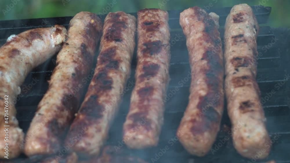 sausages are grilled on coals cooking on a grill sausages are grilled on coals cooking on a grill