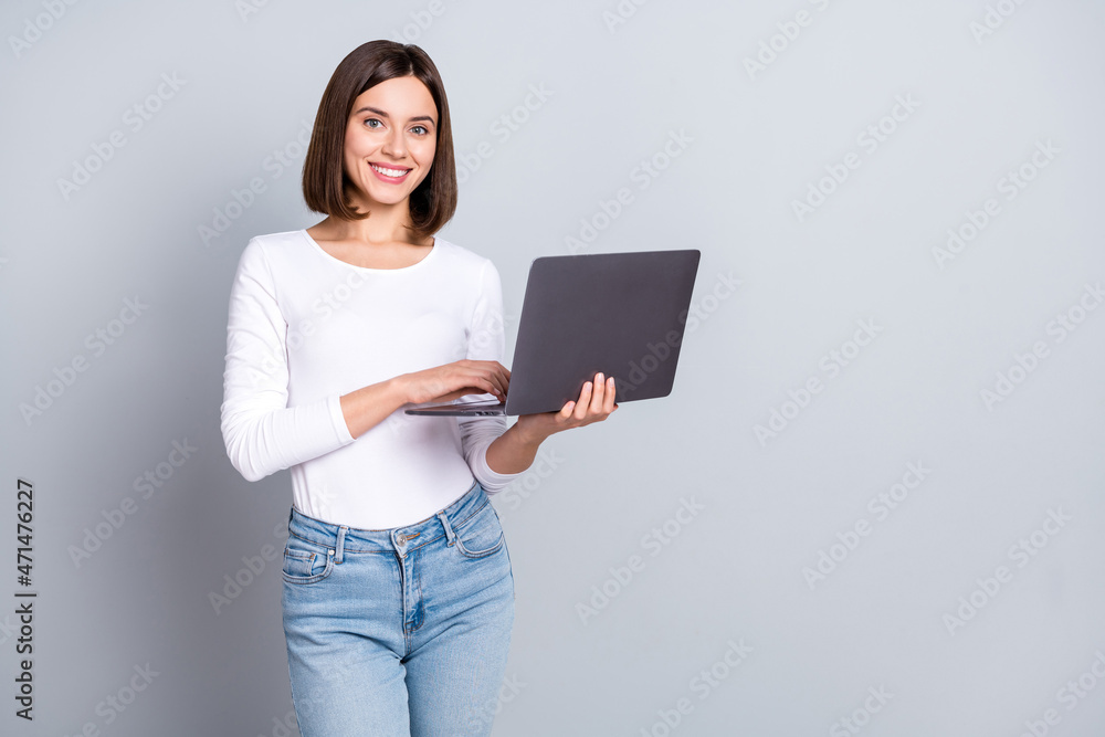 Photo of optimistic bob hairstyle hr lady hold laptop wear white pullover isolated on grey color background Photo of optimistic bob hairstyle hr lady hold laptop wear white pullover isolated on grey color background