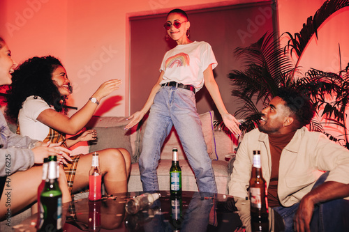 Photography Young woman dancing for her friends at a house party