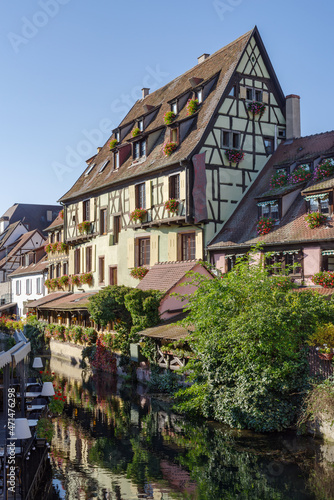 Traditional Alsatian half-timbered houses along the Lauch River in Little Venice tourist district of Colmar, France © Dmytro Surkov