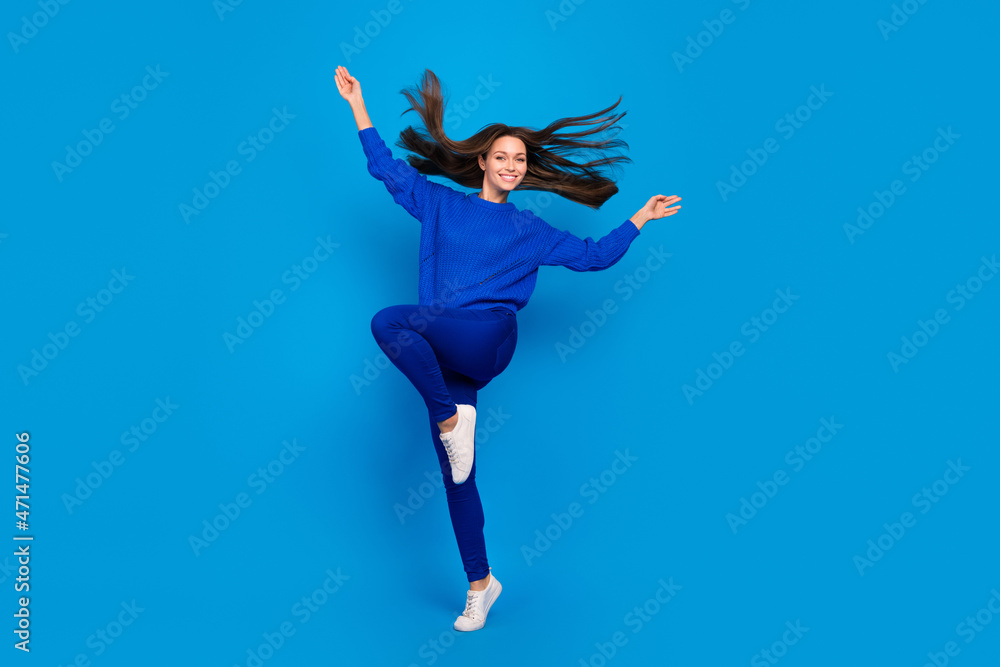 Full length body size view of attractive cheery carefree girl dancing having fun jumping isolated on vivid blue color background